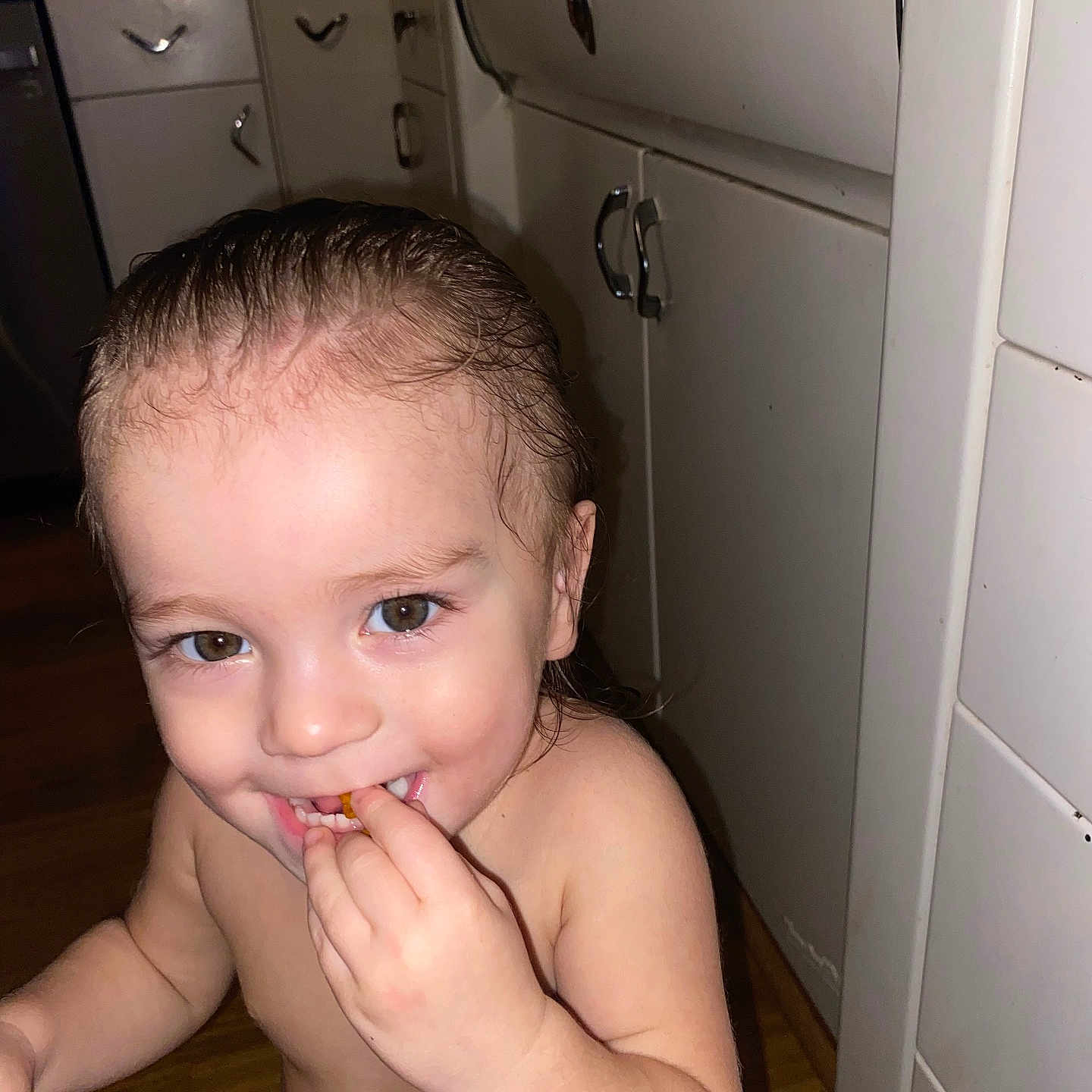 Ashton is registered to the contest to win money with this photo: baby, bodypart, cabinet, closet, cupboard, cutlery, drawer, eating, face, finger, food, furniture, hand, head, indoors, mouth, person, photography, portrait, spoon
