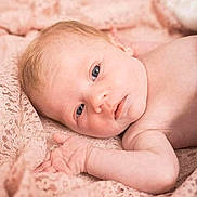 Léonie participe au concours pour gagner de l'argent avec cette photo : baby, blanket, blue_eyes, child, closeup, cute, face, hand, human, infant, lace, lying_down, newborn, peaceful, portrait, resting, skin, soft_texture, warm, young