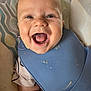 baby, smiling, food, bib, high_chair, face, mouth_open, happy, child, messy, infant, clothing, skin, seat, pattern, tongue, cute, cheeks, arm, indoor