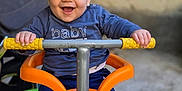 Lyam participe au concours pour gagner de l'argent avec cette photo : baby, child, smiling, cap, blue_shirt, tricycle, toy, outdoor, happy, hands, face, person, footwear, pants, play, ride, vehicle, colorful, young, expression