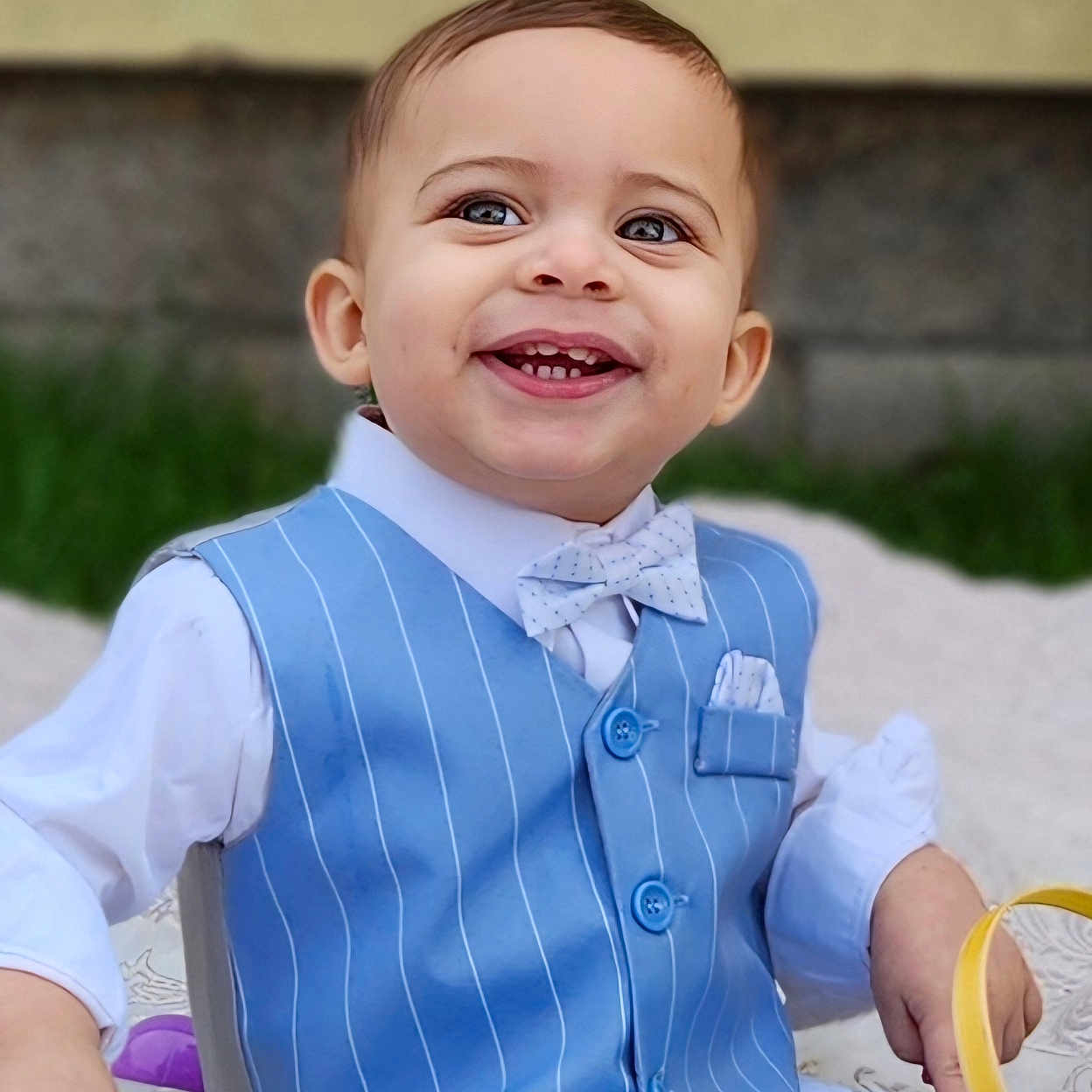 Timothy is registered to the contest to win money with this photo: accessories, baby, bodypart, clothing, dress, face, formalwear, glove, happy, head, mouth, person, photography, portrait, shirt, sitting, smile, teeth, tie, vest
