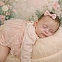 baby, infant, sleeping, tutu, bow, headband, pink, pastel, floral_background, plush_pouf, cozy, peaceful, portrait, newborn, closed_eyes, soft_texture, hand, studio_photography, cute, dress