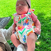 Maeve joined the competition — help win amazing prizes! baby, infant, sleeping, outdoor, grass, playground, headband, colorful_clothing, floral_pattern, person, child, hand, sock, nature, daylight, park, bench, relaxation, cute, peaceful