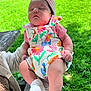 baby, infant, sleeping, outdoor, grass, playground, headband, colorful_clothing, floral_pattern, person, child, hand, sock, nature, daylight, park, bench, relaxation, cute, peaceful