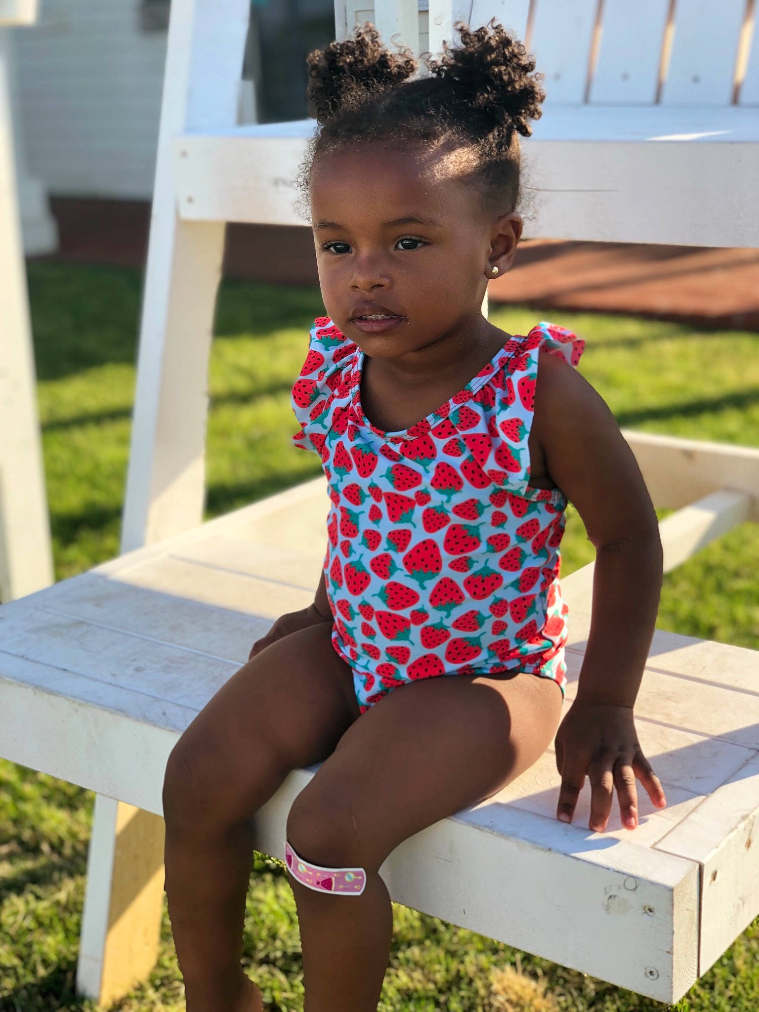 Johanna joined the competition — help win amazing prizes! baby_toddler_clothing, child, child_model, clothing, design, furniture, grass, headwear, leg, leotard, maillot, one_piece_swimsuit, pattern, person, sitting, sportswear, summer, swimwear, textile, tights