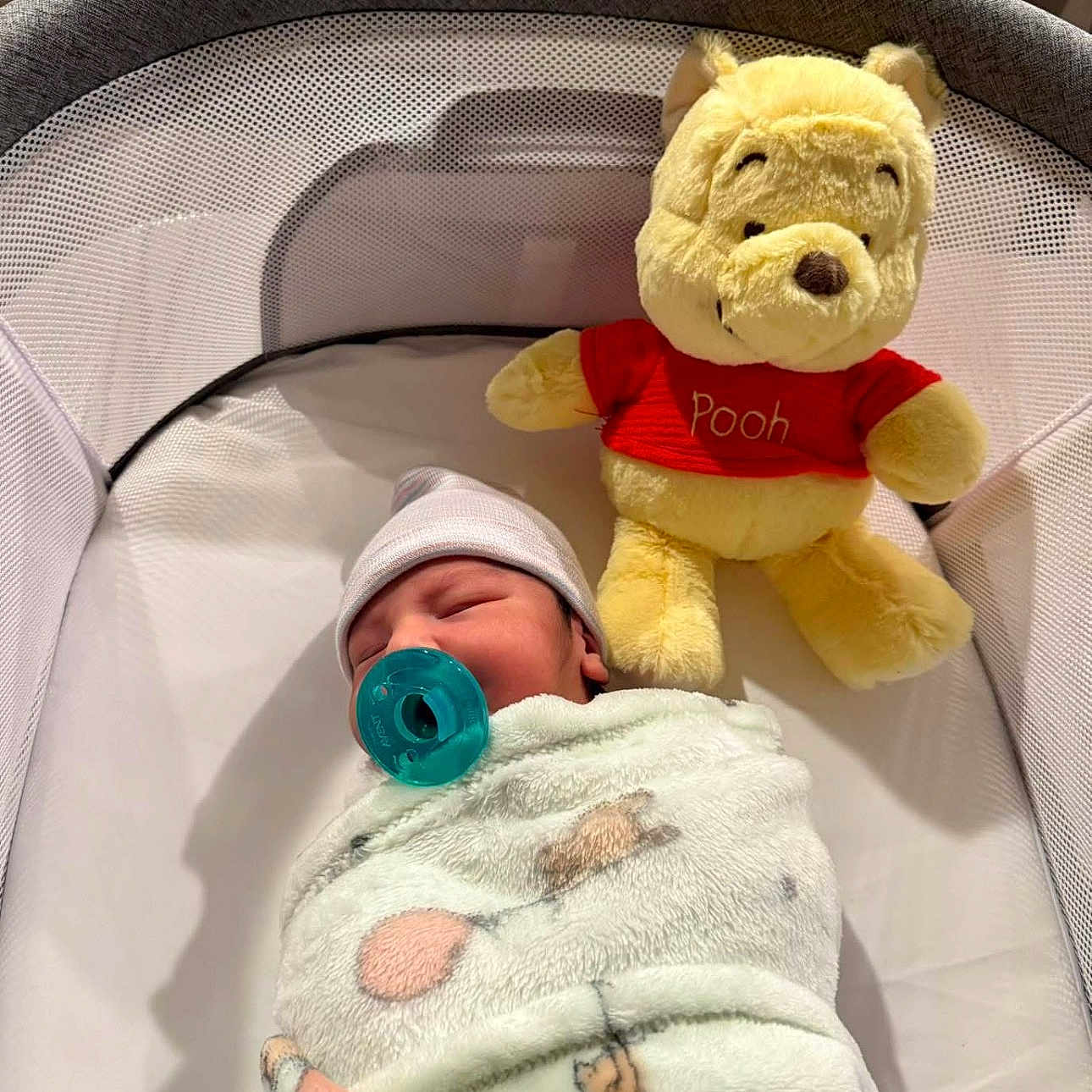 Josiah is registered to the contest to win money with this photo: baby, bassinet, blanket, child, comfort, cozy, cute, hat, indoor, infant, newborn, nursery, pacifier, peaceful, person, plush_toy, resting, sleeping, soft_toy, winnie_the_pooh