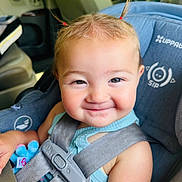 Briella is registered to the contest to win money with this photo: toddler, child, car_seat, smile, happy, baby, seatbelt, plush_toy, pigtails, blue_clothing, vehicle_interior, safety_harness, cute, portrait, infant, young_child, seat, head, person, baby_toy