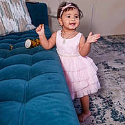 Saesha joined the competition — help win amazing prizes! child, toddler, girl, portrait, smiling, happy, pink_dress, headband, necklace, party, celebration, sofa, couch, living_room, rug, indoor, standing, barefoot, toy, candid