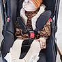 baby, infant, car_seat, stroller, headband, bow, face, seat_belt, buckle, tights, patterned_clothing, fur_trim, hand, wheel, pensive_expression, cute, portrait, indoors, footwear_bow, child