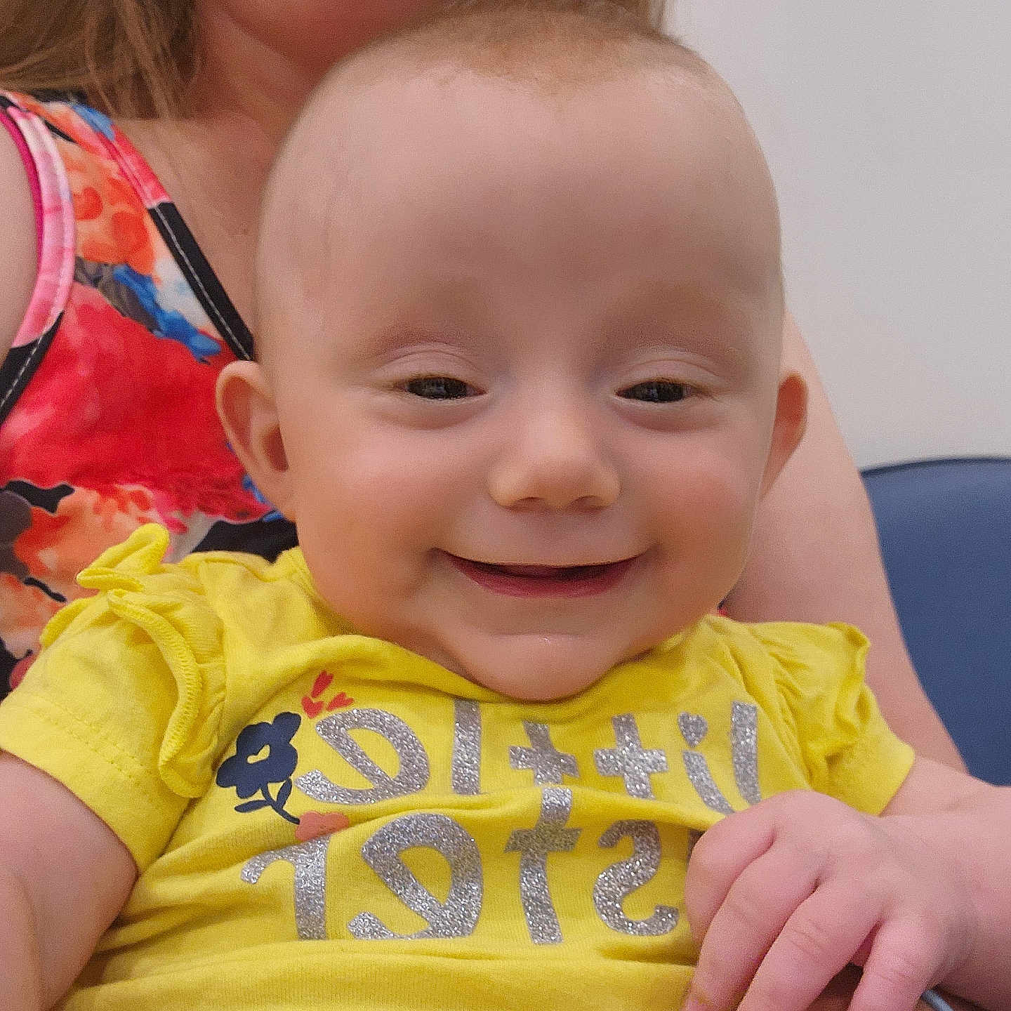 Emma joined the competition — help win amazing prizes! accessories, arm, baby, bodypart, clothing, face, finger, hand, happy, head, laughing, mouth, newborn, person, photography, portrait, sitting, smile, t_shirt, teeth