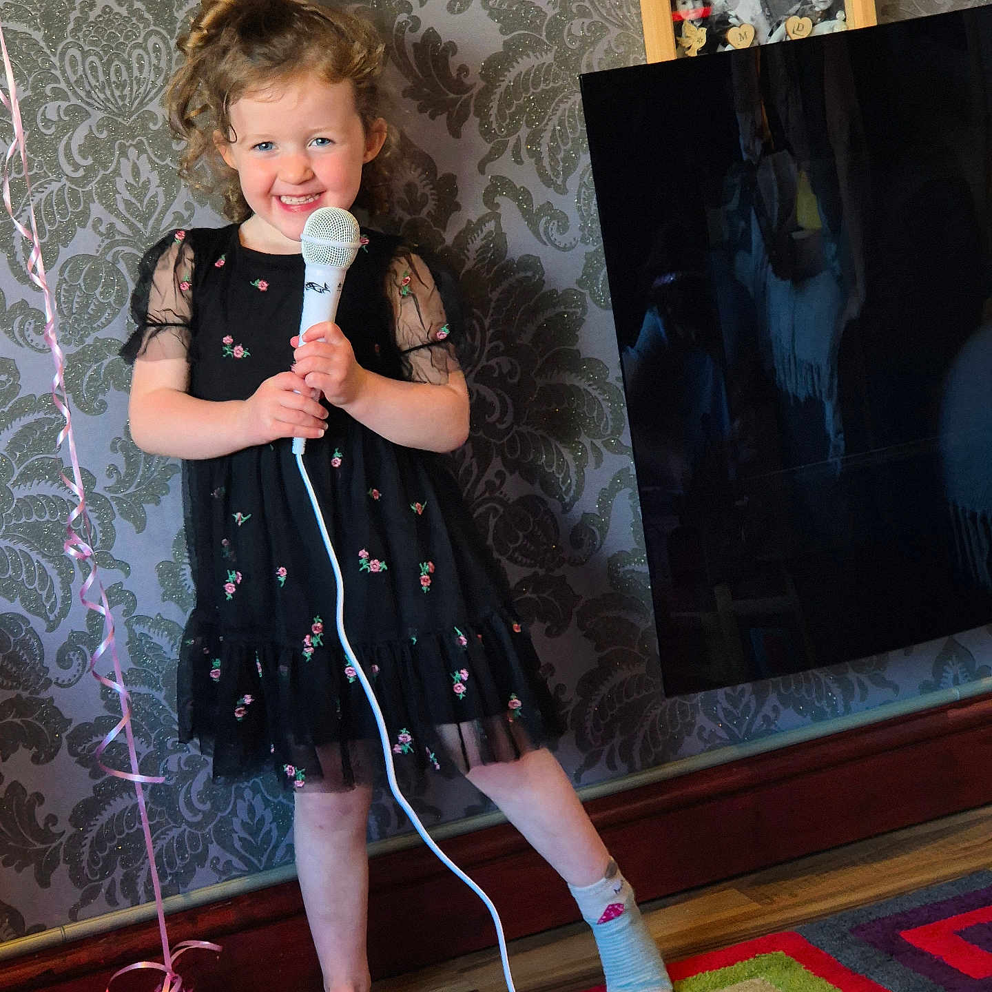 Charlotte is registered to the contest to win money with this photo: child, clothing, computerhardware, couch, dress, electricaldevice, electronics, face, female, furniture, girl, hardware, head, hosiery, microphone, monitor, person, screen, sock, tv