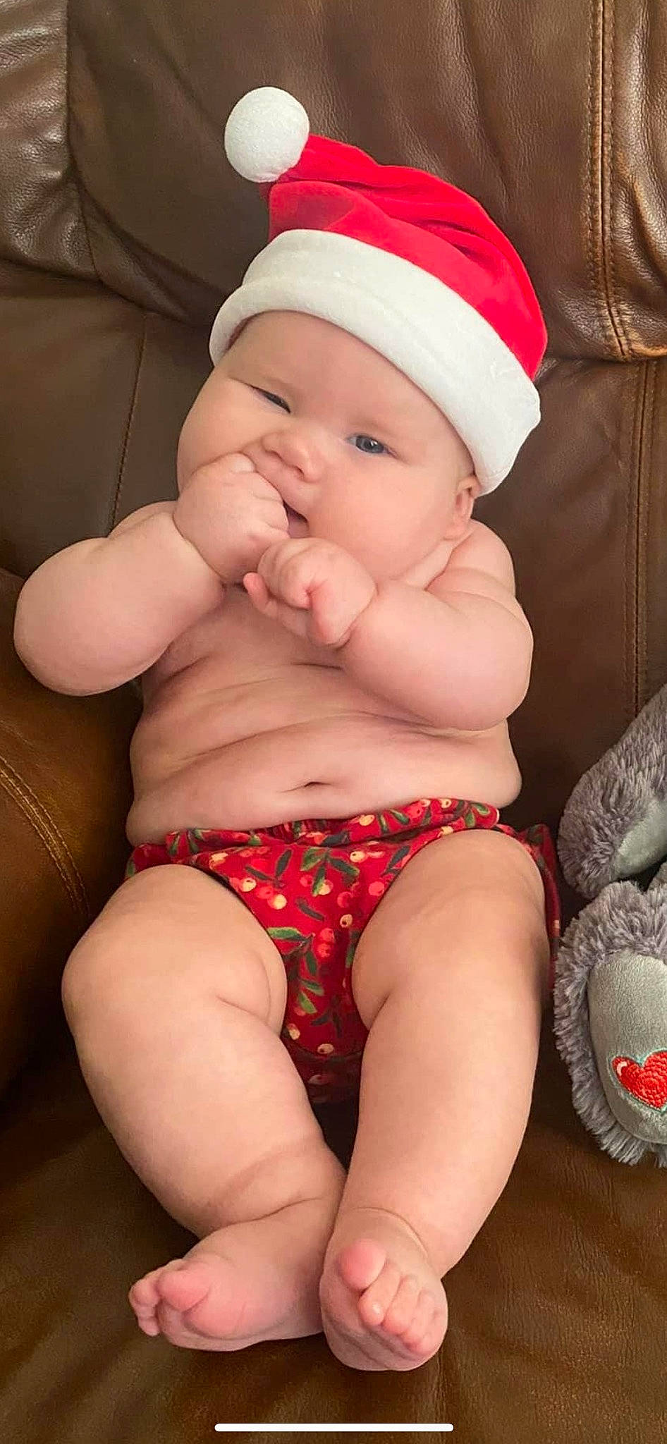 Jordyn is registered to the contest to win money with this photo: baby, chest, comfort, eye, face, facial_expression, head, headwear, knee, lap, leg, mouth, muscle, organ, person, pink, red, skin, stomach, thigh