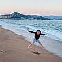 Erik joined the competition — help win amazing prizes! child, beach, jumping, sand, ocean, waves, mountains, sunset, water, shore, playful, happy, outdoor, sky, coast, nature, person, clothing, fun, active