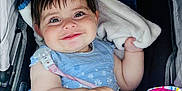 Adelaide joined the competition — help win amazing prizes! baby, child, smile, flower_headband, blue_dress, blanket, toy, stroller, hand, face, happy, infant, cute, portrait, indoors, person, clothing, baby_toy, head, sitting