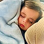 Adelaide is registered to the contest to win money with this photo: child, sleeping, blanket, soft, cozy, face, closed_eyes, cushion, comfort, indoor, peaceful, rest, nap, young_child, portrait, warm, furniture, relaxation, head, toddler
