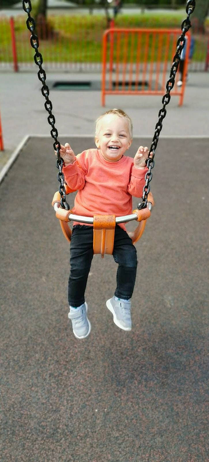 Harvey is registered to the contest to win money with this photo: asphalt, baby, child, city, electric_blue, fashion_accessory, fun, happy, jewellery, joy, leisure, person, play, playground, pole, recreation, sleeve, smile, street_fashion, swing