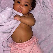 Blessynn is registered to the contest to win money with this photo: baby, infant, blanket, pink, curly_hair, lying_down, cute, soft_texture, child, skin, clothing, foot, hand, face, expression, indoors, warm, cozy, toddler, newborn