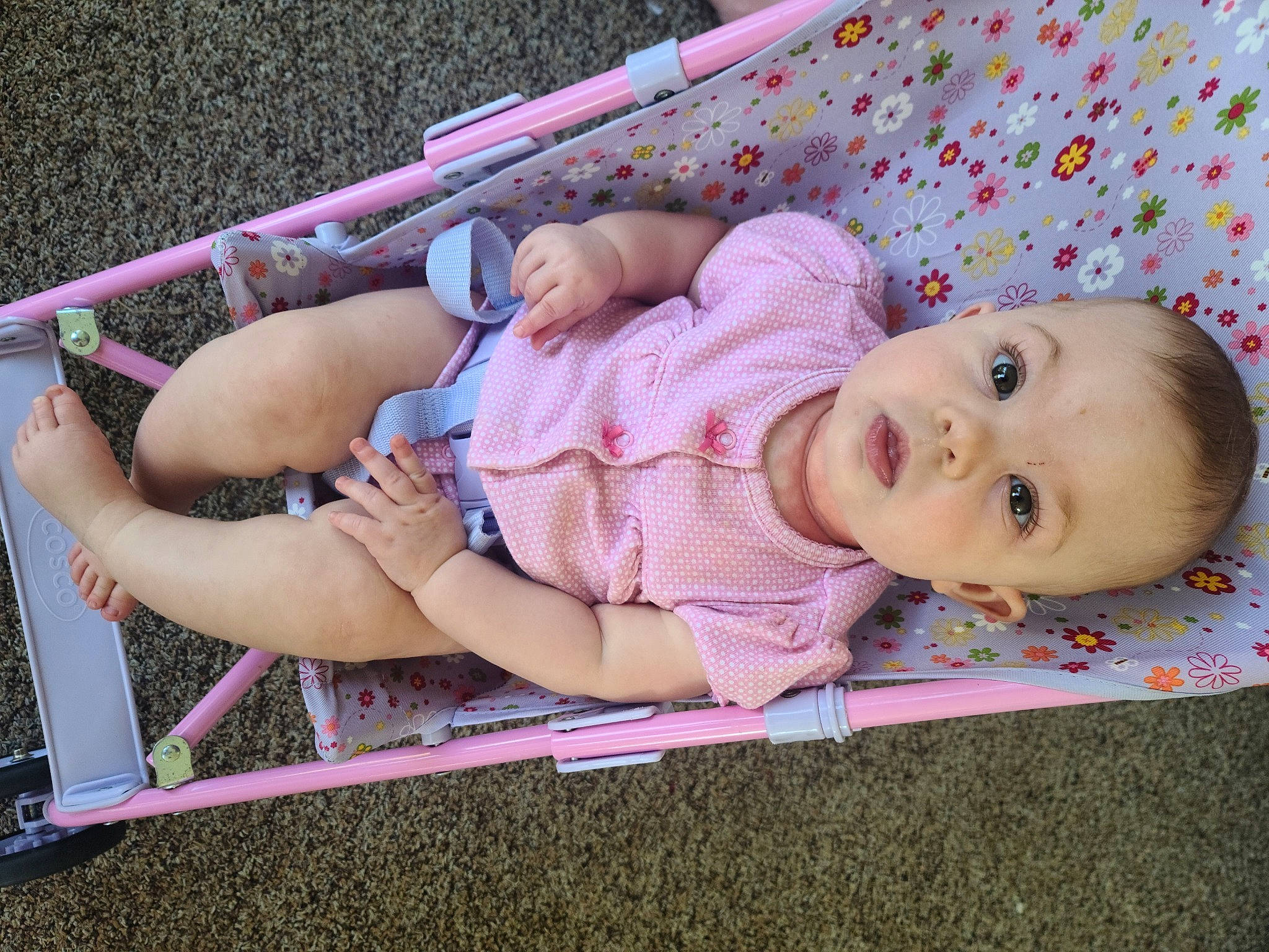 Dixie is registered to the contest to win money with this photo: baby, baby_products, baby_toddler_clothing, cheek, child, comfort, foot, fun, grass, human_leg, magenta, pattern, person, pink, sitting, skin, sock, thigh, toddler, vacation