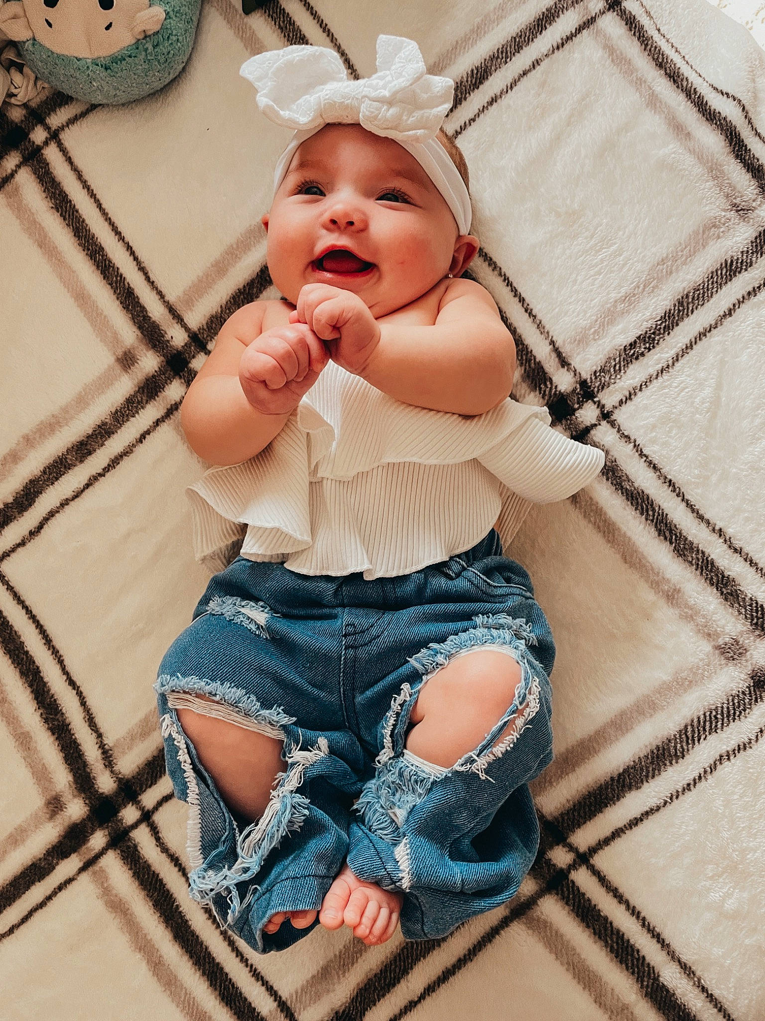 Leyla is registered to the contest to win money with this photo: arm, baby, baby_toddler_clothing, child, comfort, hand, happy, hat, headwear, human_body, jeans, mouth, pattern, person, pink, skin, sleeve, smile, swing, thigh
