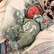 Delilah joined the competition — help win amazing prizes! newborn, baby, infant, child, portrait, lying_down, sleeping, smiling, face, daisy, floral, mint_green, clothing, hat, mittens, blanket, bed, bedding, cozy, indoors