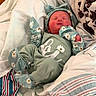 newborn, baby, infant, child, portrait, lying_down, sleeping, smiling, face, daisy, floral, mint_green, clothing, hat, mittens, blanket, bed, bedding, cozy, indoors
