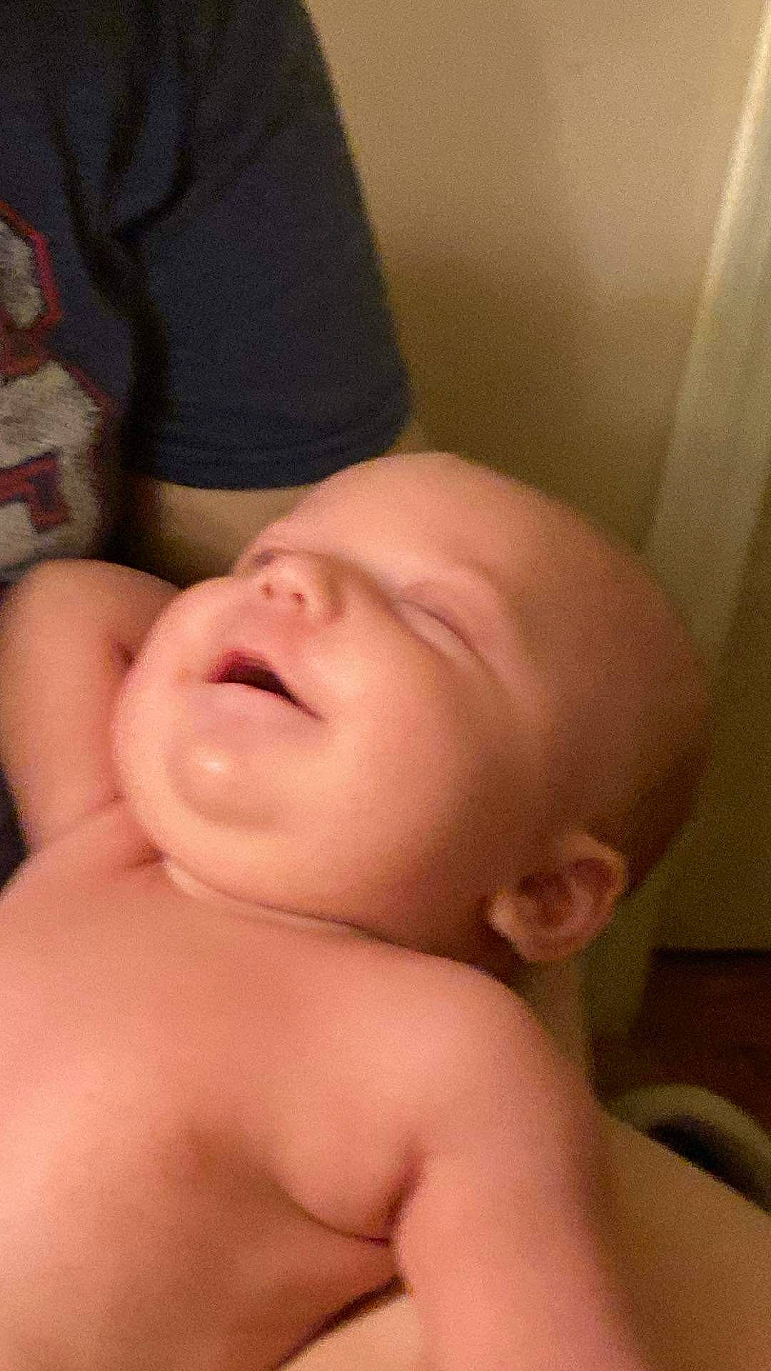 Logan is registered to the contest to win money with this photo: arm, baby, cheek, chest, comfort, ear, eye, eyebrow, eyelash, gesture, hand, human_body, jaw, leg, lip, mouth, neck, nose, person, skin