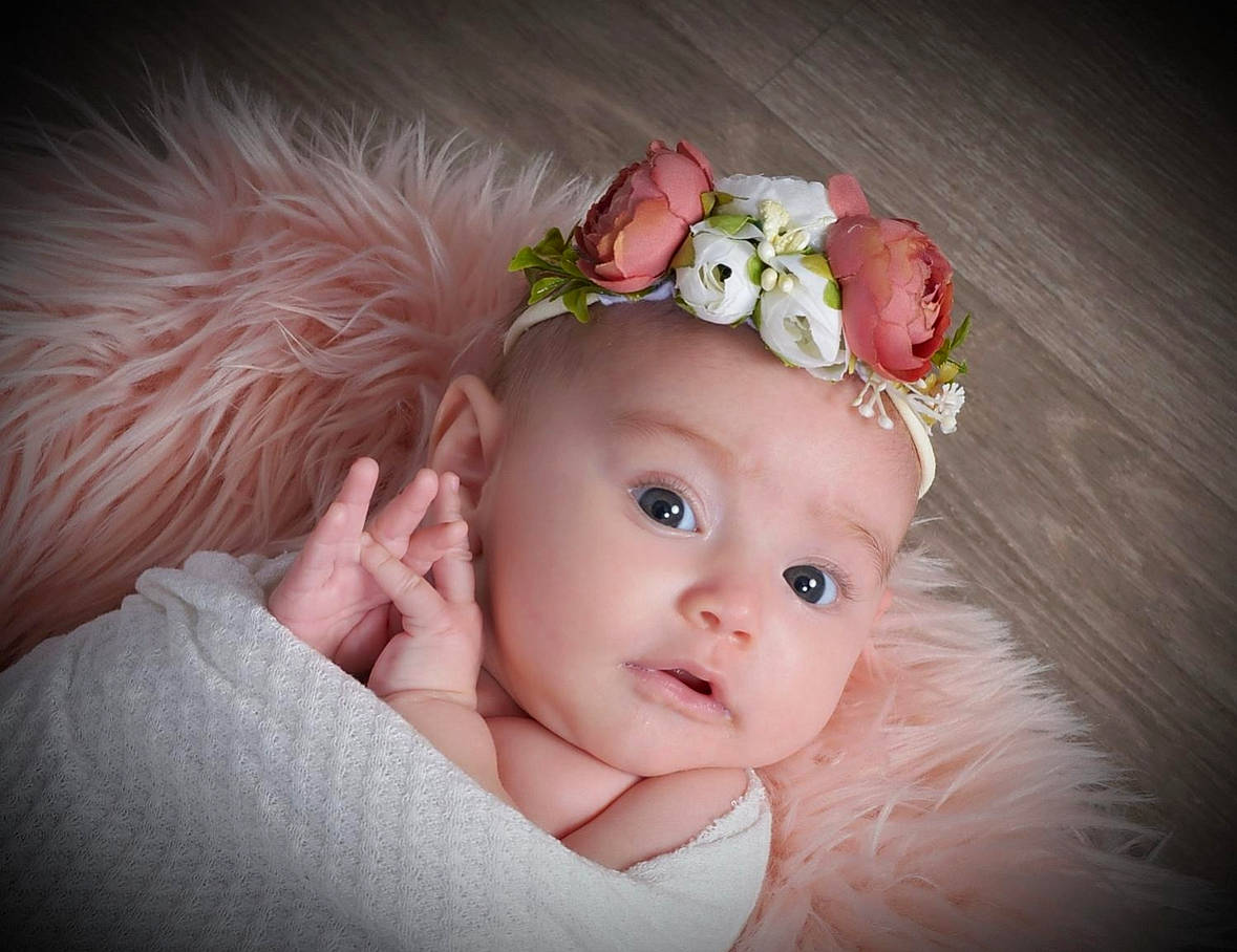 Megan joined the competition — help win amazing prizes! baby, baby_toddler_clothing, dress, eye, eyebrow, eyelash, flash_photography, flower, grass, happy, head, headband, headgear, headpiece, headwear, iris, lip, person, petal, pink