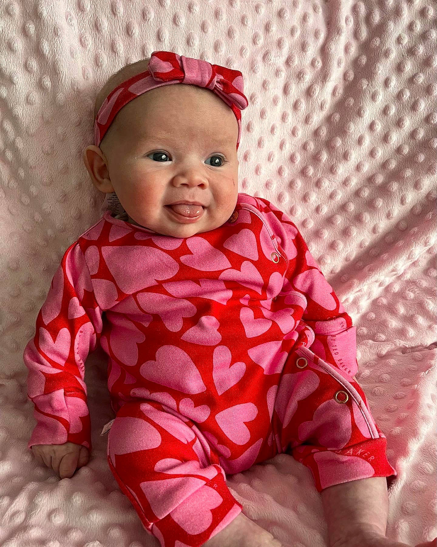 Indigo joined the competition — help win amazing prizes! baby, baby_laughing, baby_toddler_clothing, cap, comfort, dress, face, happy, headwear, human_body, lip, magenta, outerwear, pattern, person, pink, red, skin, sleeve, smile