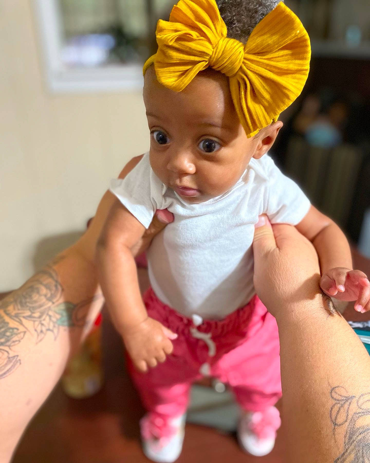 Karlee is registered to the contest to win money with this photo: arm, baby, baby_toddler_clothing, chin, eye, face, facial_expression, finger, happy, human_body, joint, mouth, organ, person, pink, skin, sleeve, textile, toddler, toy