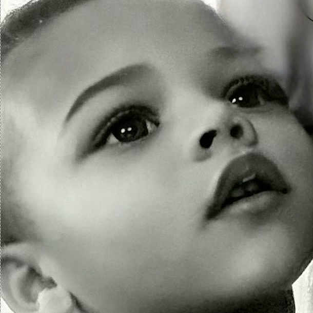 Desyrai is registered to the contest to win money with this photo: child, portrait, black_and_white, face, curly_hair, looking_up, innocence, close_up, soft_light, expression, young_child, monochrome, curtain, young_face, innocent, candid, childhood, thoughtful, profile, emotion