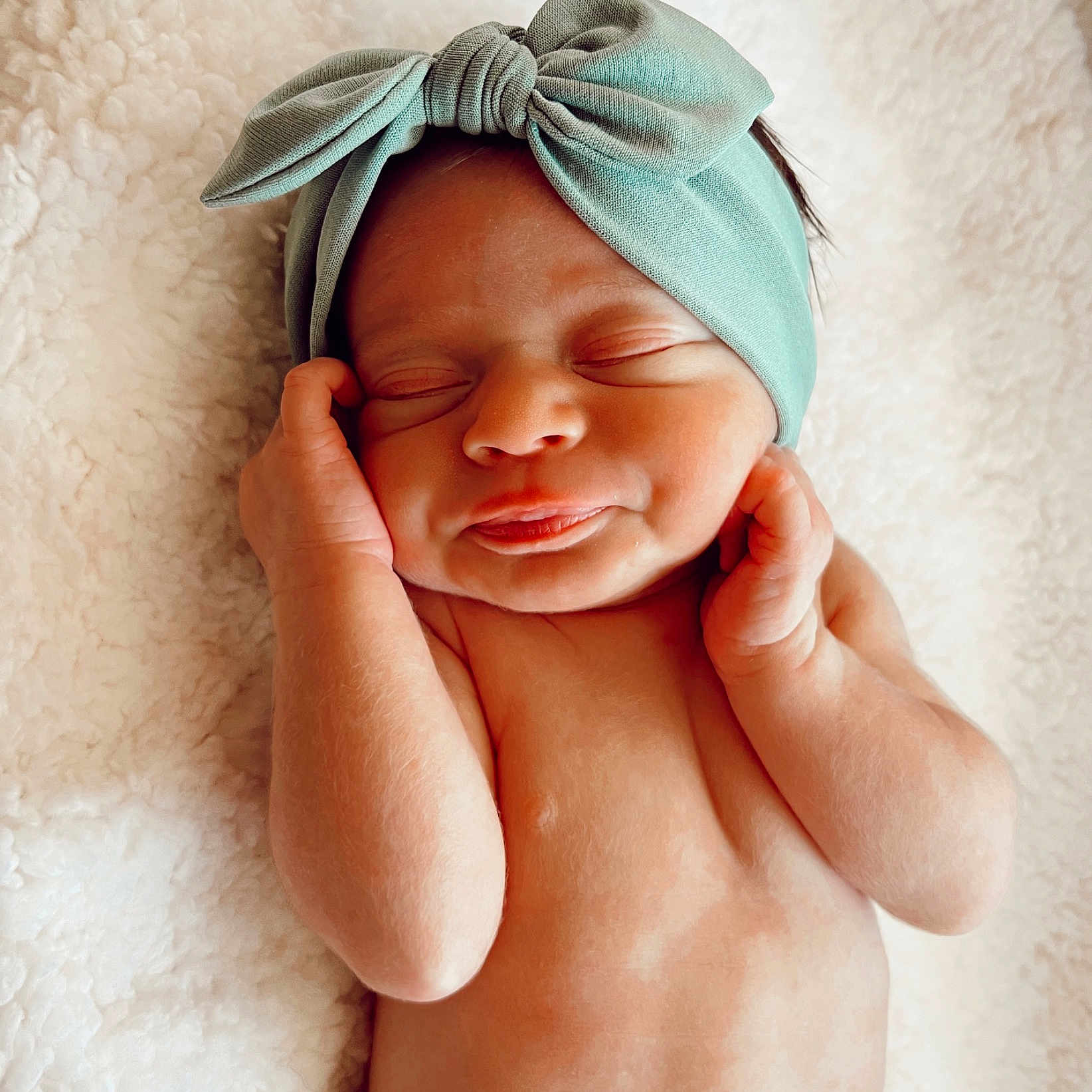 Lennon is registered to the contest to win money with this photo: baby, cap, comfort, eyebrow, face, fashion_accessory, finger, gesture, hand, happy, headband, headgear, headpiece, linens, lip, neck, skin, smile, thumb, toddler