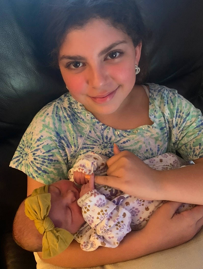 Khloe is registered to the contest to win money with this photo: abdomen, arm, comfort, elbow, flash_photography, hand, happy, headwear, human_body, human_leg, iris, jewellery, joy, lap, mouth, neck, person, sitting, skin, smile