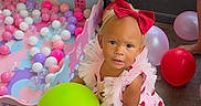 Haislyn joined the competition — help win amazing prizes! ball_pit, balloon, child, colorful, concrete_floor, cute, footwear, happy, indoor, person, pink_balls, play_area, playtime, purple_balls, red_bow, strawberry_dress, summer, toddler, toy, white_balls