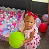 Haislyn joined the competition — help win amazing prizes! toddler, child, balloon, red_bow, strawberry_dress, ball_pit, pink_balls, purple_balls, white_balls, play_area, indoor, concrete_floor, colorful, happy, person, cute, toy, playtime, footwear, summer