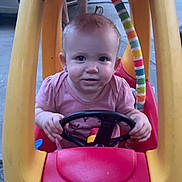 Emilee is registered to the contest to win money with this photo: baby, child, toy_car, steering_wheel, little_tikes, outdoor, person, pink_shirt, yellow_roof, red_car, face, hands, legs, concrete, playtime, cute, expression, small_toy, vehicle, fun