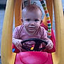 baby, child, toy_car, steering_wheel, little_tikes, outdoor, person, pink_shirt, yellow_roof, red_car, face, hands, legs, concrete, playtime, cute, expression, small_toy, vehicle, fun