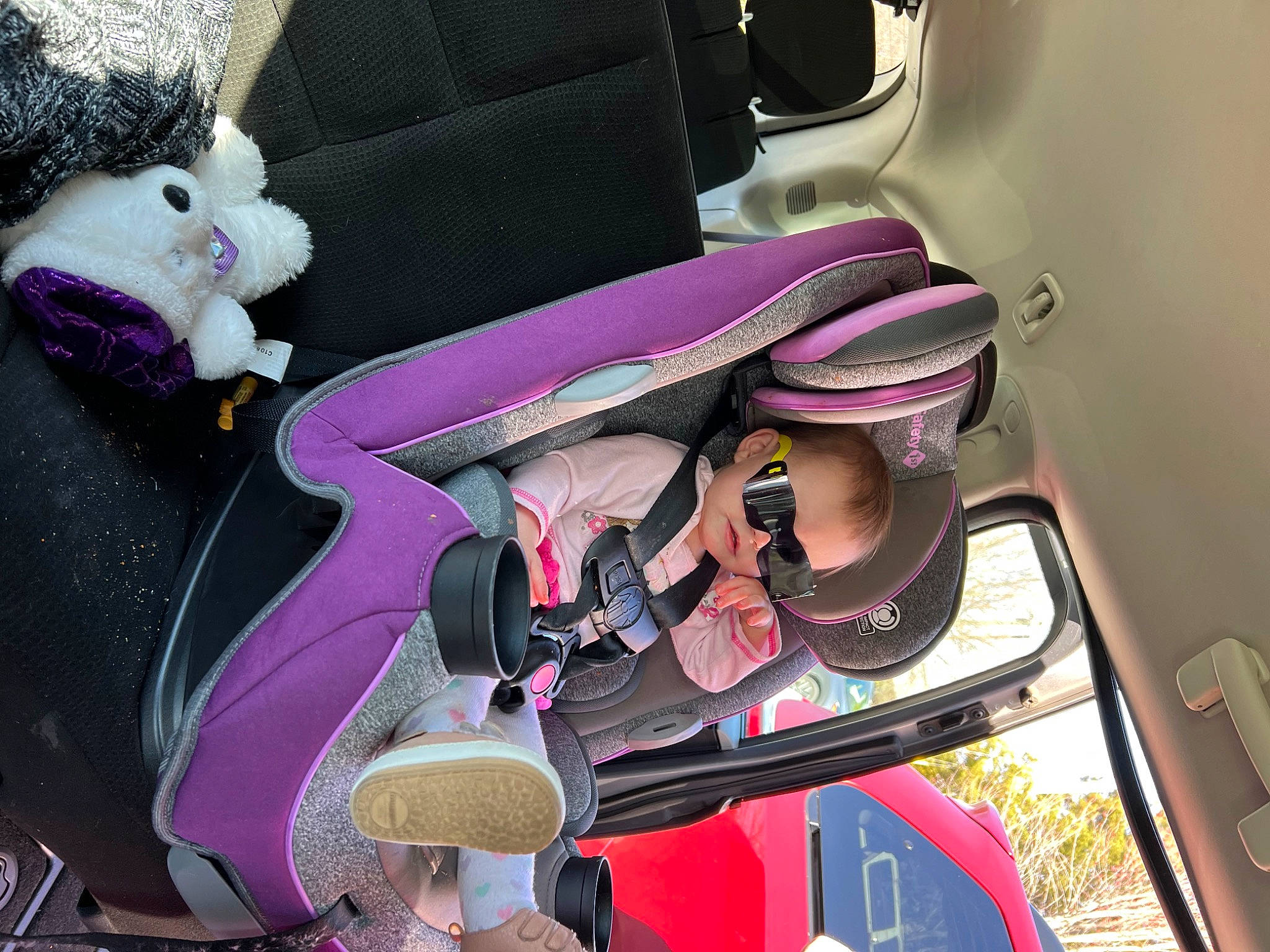 Angel is registered to the contest to win money with this photo: auto_part, automotive_design, automotive_exterior, bag, car_seat, car_seat_cover, eyewear, family_car, fashion_accessory, head_restraint, luggage_and_bags, luxury_vehicle, magenta, motor_vehicle, person, personal_protective_equipment, purple, seat_belt, steering_wheel, vehicle