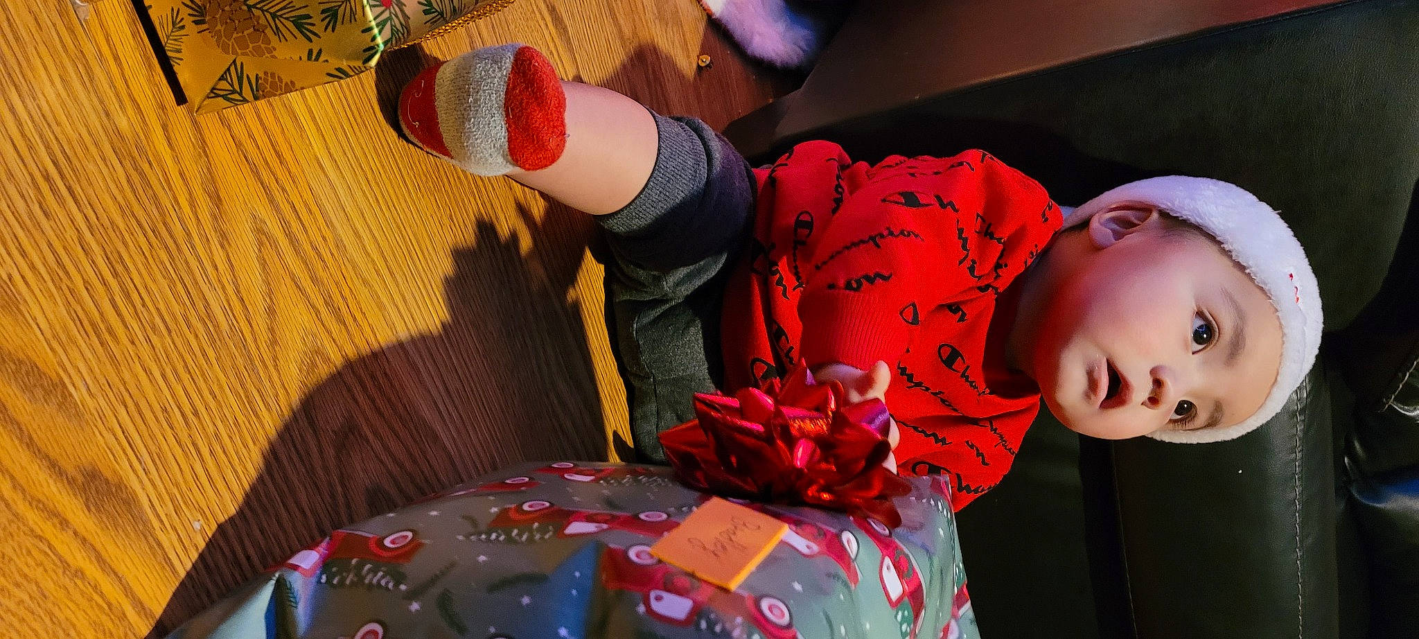 Bradley is registered to the contest to win money with this photo: audio_equipment, baby, carmine, child, event, flooring, fun, headwear, human_leg, leisure, magenta, nail, party, pattern, person, play, recreation, red, room, textile