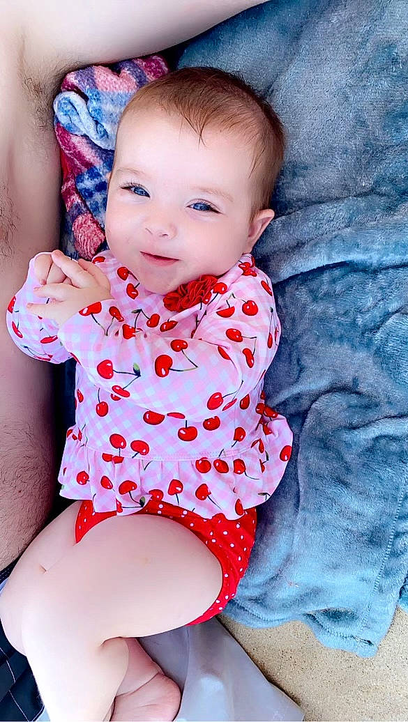 Camryn is registered to the contest to win money with this photo: baby_toddler_clothing, cheek, eye, face, facial_expression, flash_photography, hairstyle, head, joint, leg, lip, mouth, neck, person, pink, purple, skin, sleeve, standing, stomach