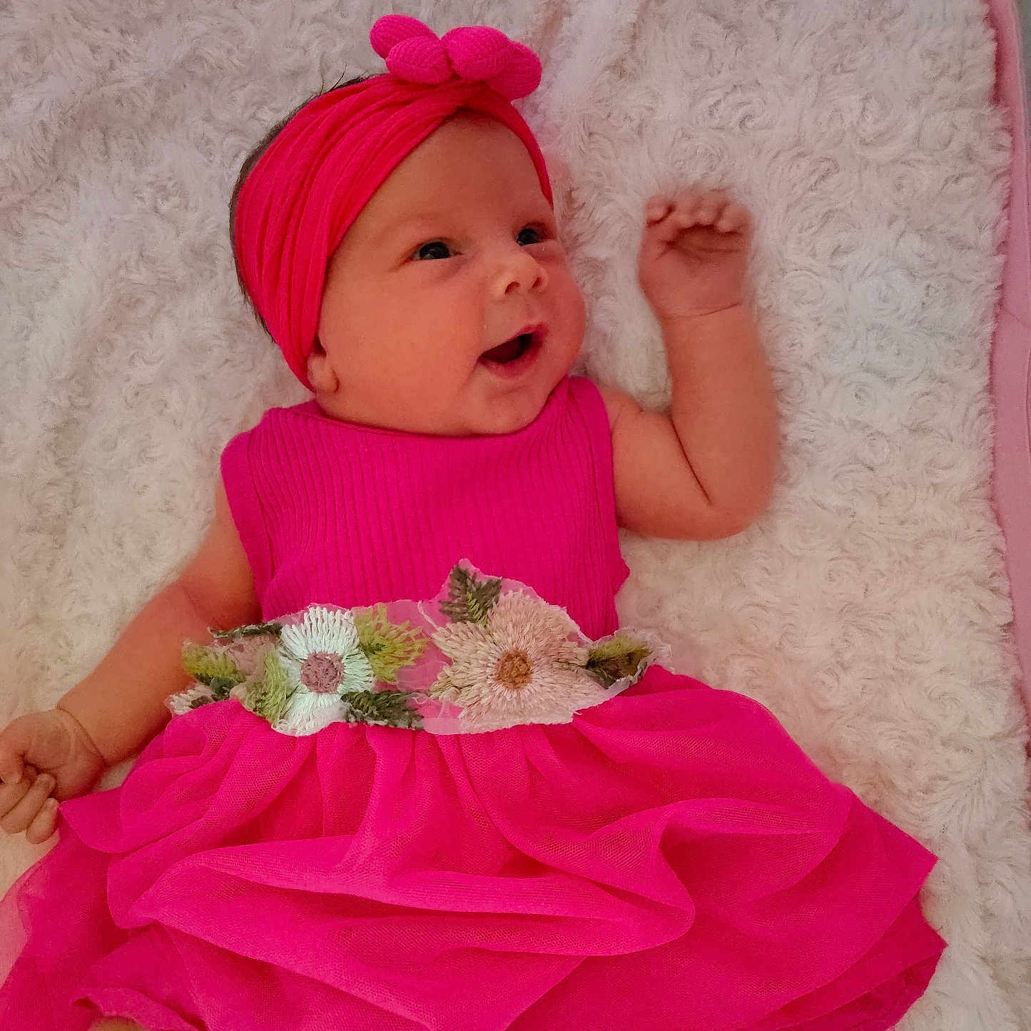 Paisley is registered to the contest to win money with this photo: baby, blanket, child, cute, fabric, flower_pattern, foot, hand, happy, headband, indoors, infant, lying_down, pink_dress, playful, portrait, skin, smiling, soft_texture, young