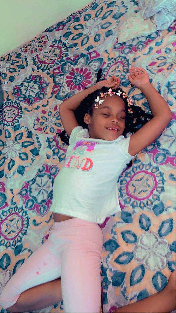 Nevaeh is registered to the contest to win money with this photo: arm, baby, baby_toddler_clothing, black_hair, comfort, cool, face, finger, hand, happy, headwear, joy, magenta, mouth, person, pink, purple, skin, sleeve, t_shirt