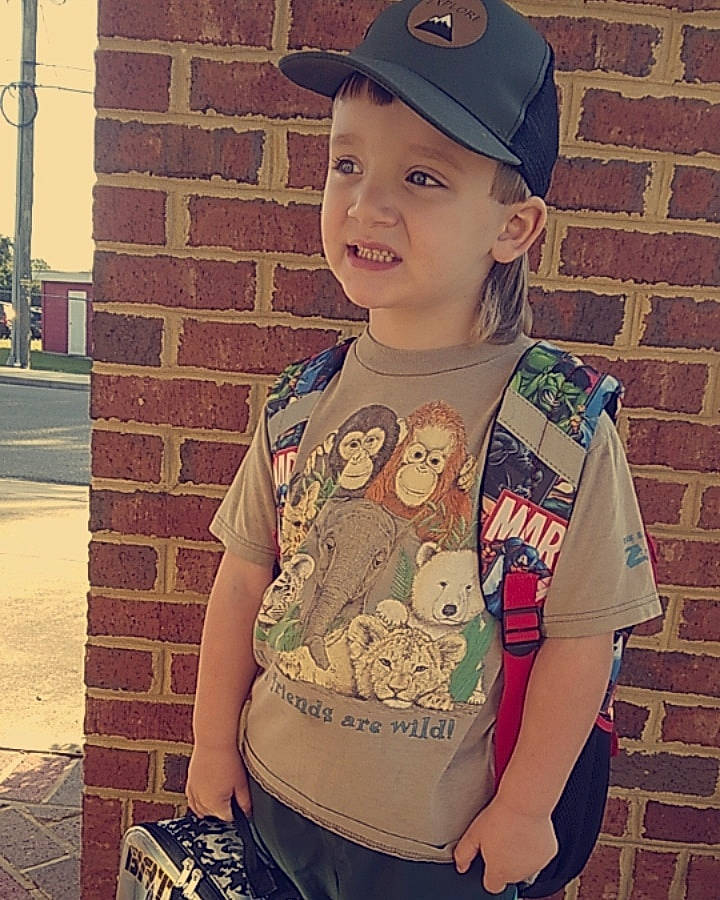 Caleb joined the competition — help win amazing prizes! arm, baseball_cap, blond, cap, child, cool, electric_blue, hairstyle, happy, headwear, neck, outerwear, pattern, person, shoulder, sleeve, smile, standing, t_shirt, toddler