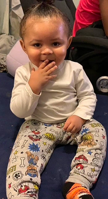 Kamren is registered to the contest to win money with this photo: baby_toddler_clothing, cheek, chin, dress, eye, face, facial_expression, finger, hair, head, iris, lip, mammal, mouth, nose, organ, person, skin, sleeve, smile