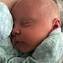 Oaklee is registered to the contest to win money with this photo: baby, sleeping, closeup, infant, soft, pastel, blue, swans, clothing, face, head, peaceful, resting, cozy, skin, newborn, cute, child, portrait, quiet
