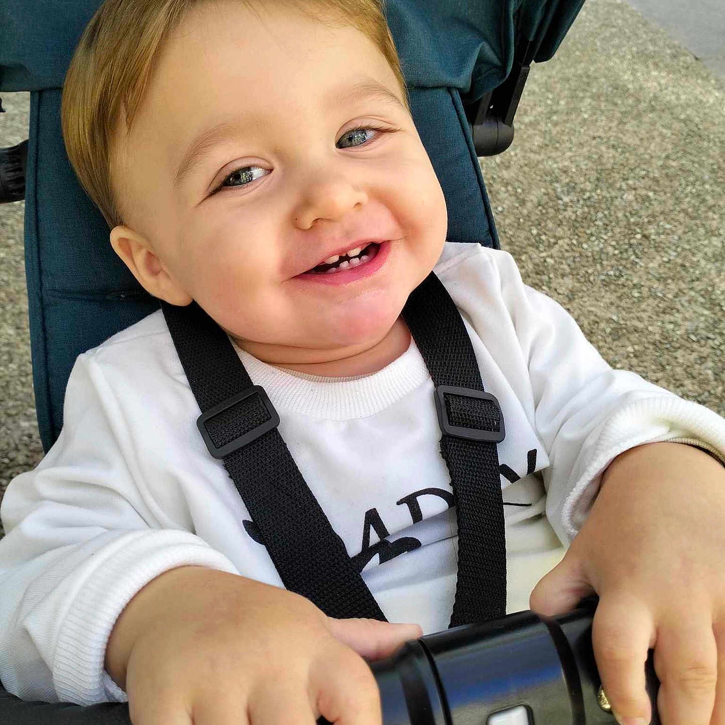 Aaron participe au concours pour gagner de l'argent avec cette photo : accessories, baby, bodypart, camera, clothing, electronics, face, finger, hand, happy, head, mouth, pants, person, photography, portrait, smile, strap, t_shirt, teeth