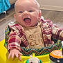 Tatum is registered to the contest to win money with this photo: baby, child, smiling, happy, plaid_shirt, walker, toy, elephant_toy, indoor, floor, person, clothing, face, mouth_open, hand, cute, infant, cheerful, play, young