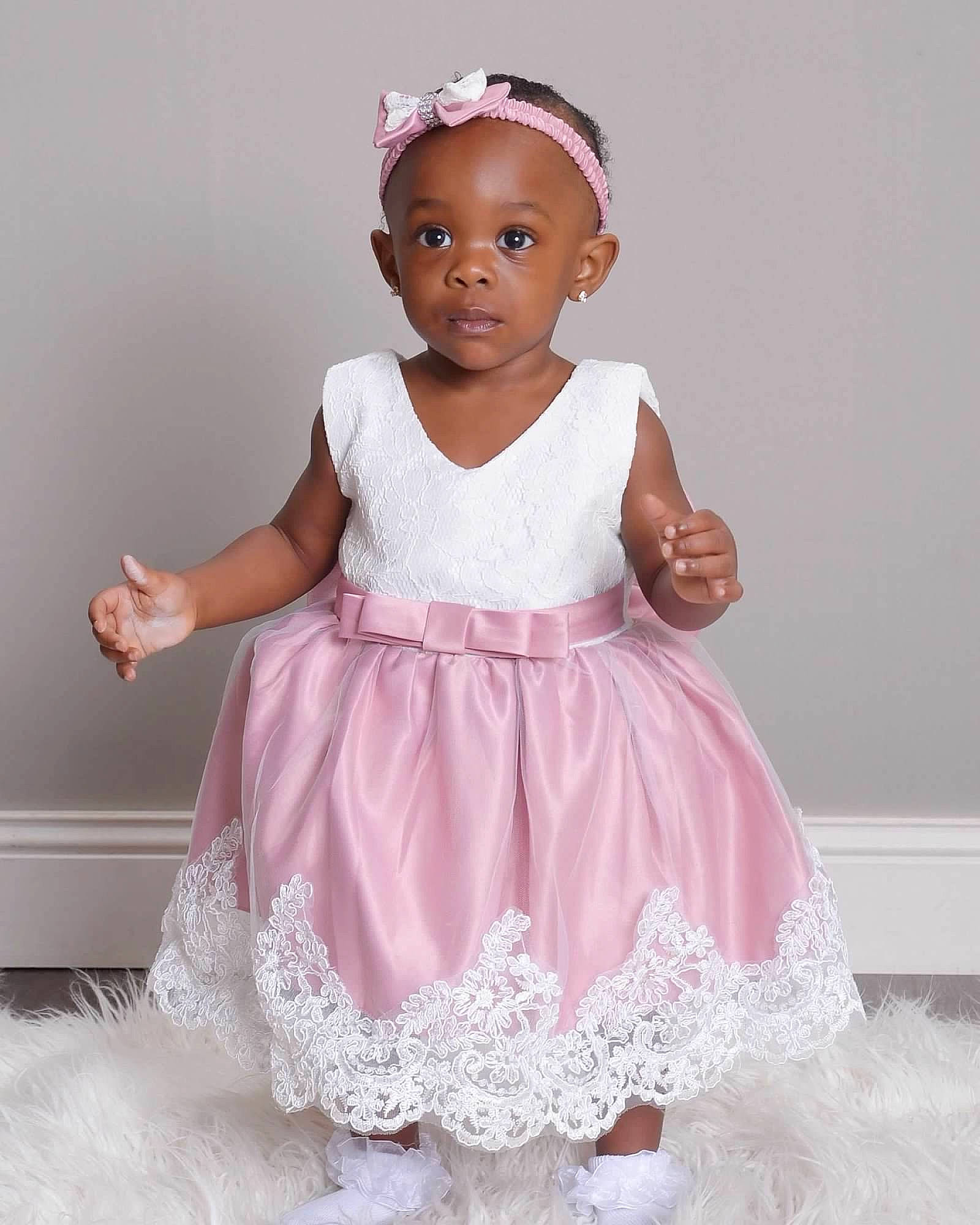Xahnea is registered to the contest to win money with this photo: baby_toddler_clothing, bridal_accessory, child, day_dress, dress, embellishment, face, fashion_design, happy, headgear, magenta, neck, one_piece_garment, pattern, person, pink, purple, ruffle, sleeve, toddler