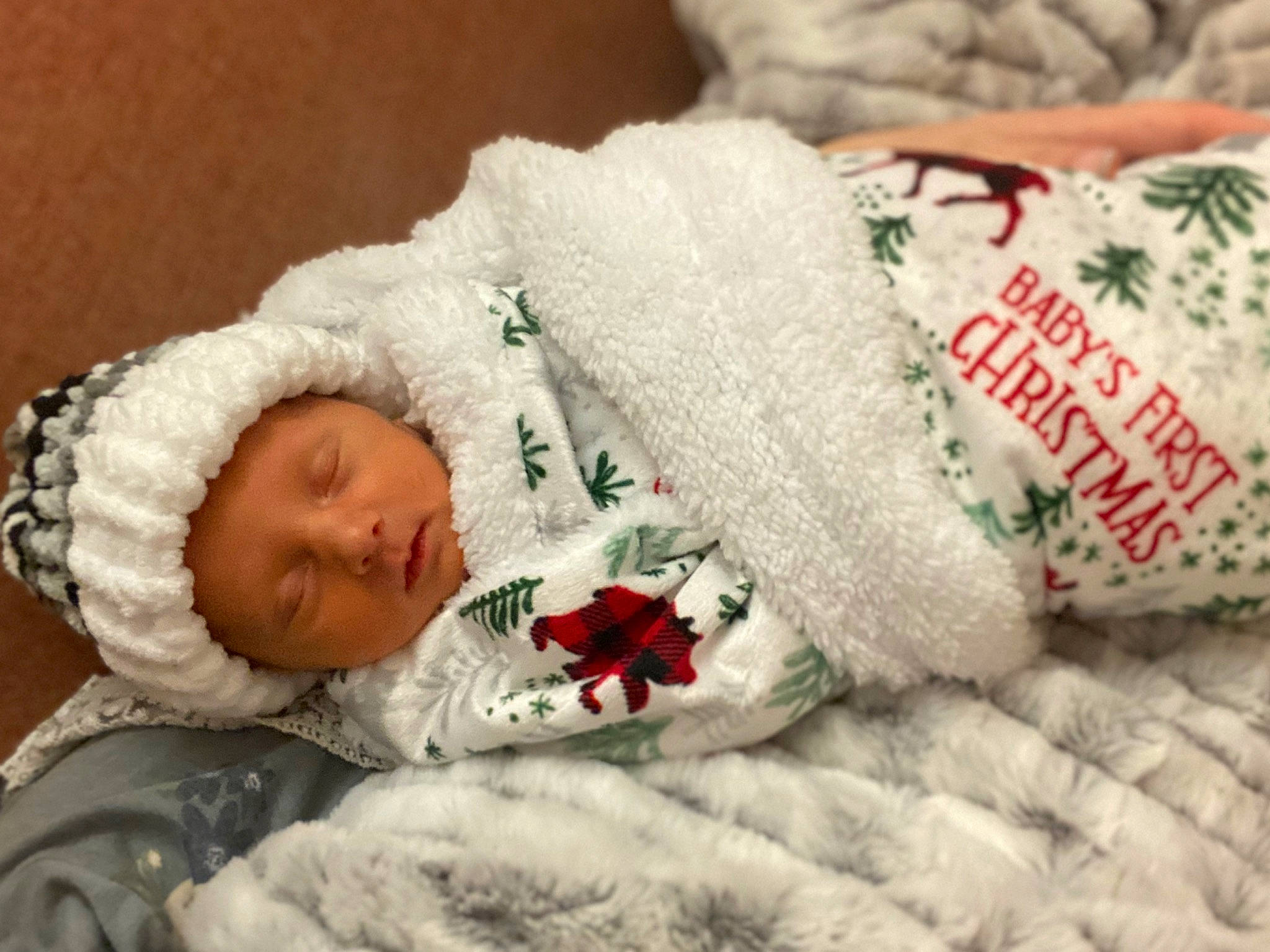 Cason is registered to the contest to win money with this photo: baby, baby_sleeping, baby_toddler_clothing, bedding, bedtime, carmine, child, christmas, comfort, event, fur, headgear, headwear, human_body, linens, person, product, room, textile, toddler