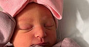Saylor joined the competition — help win amazing prizes! newborn, baby, sleeping, pink_bow, pink_clothing, infant, cozy, blanket, cute, face, peaceful, soft_lighting, portrait, indoors, child, tiny, sleep, headwear, warm, resting