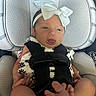 Saylor joined the competition — help win amazing prizes! baby, infant, car_seat, headband, bow, straps, clothing, person, child, cute, small_feet, black_straps, fabric, seat, car_interior, newborn, expression, portrait, sitting, closeup